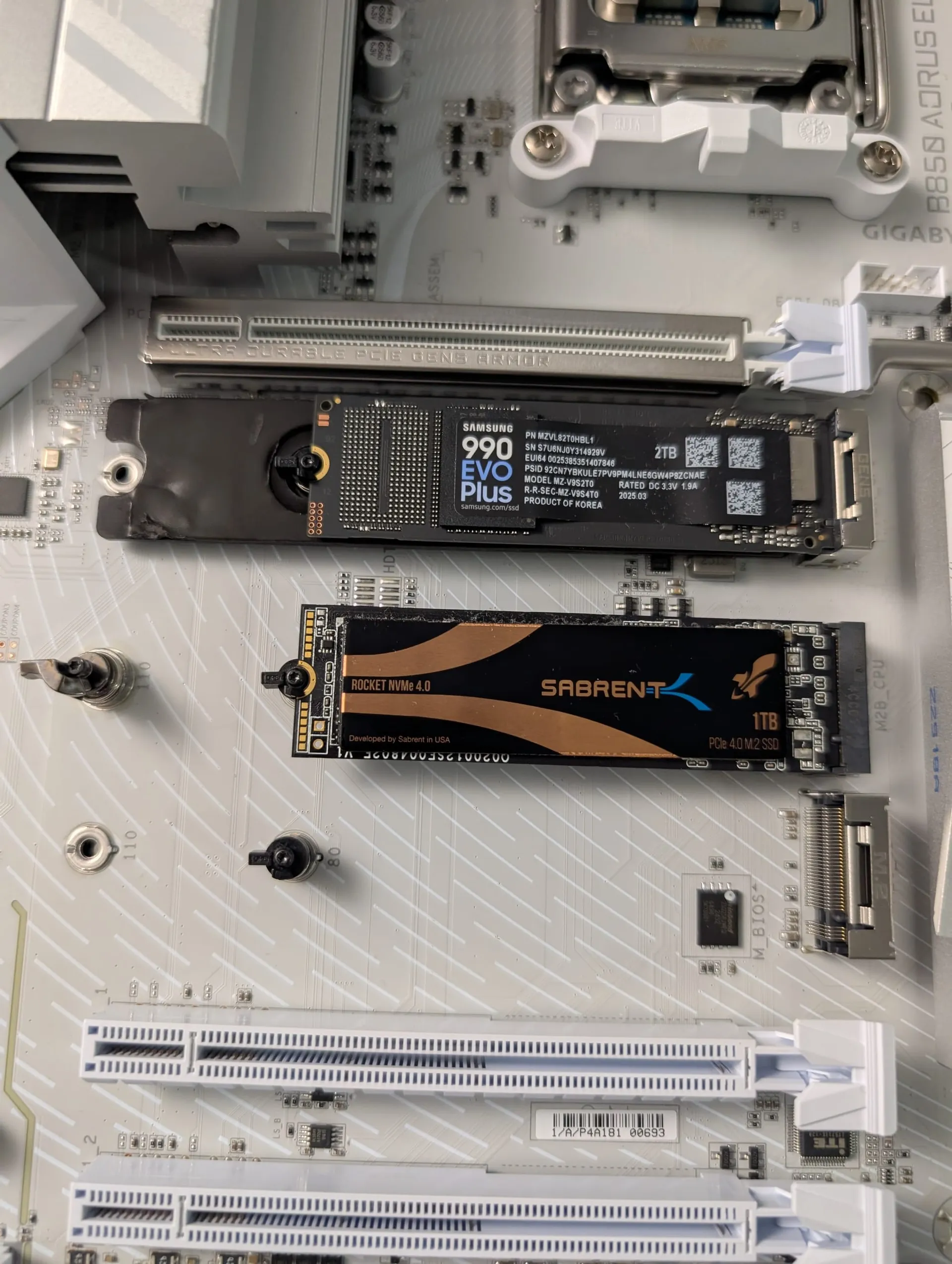 Picture of my new PC's (Dirty Snow) motherboard, showing the two NVME drives featured, installed.
