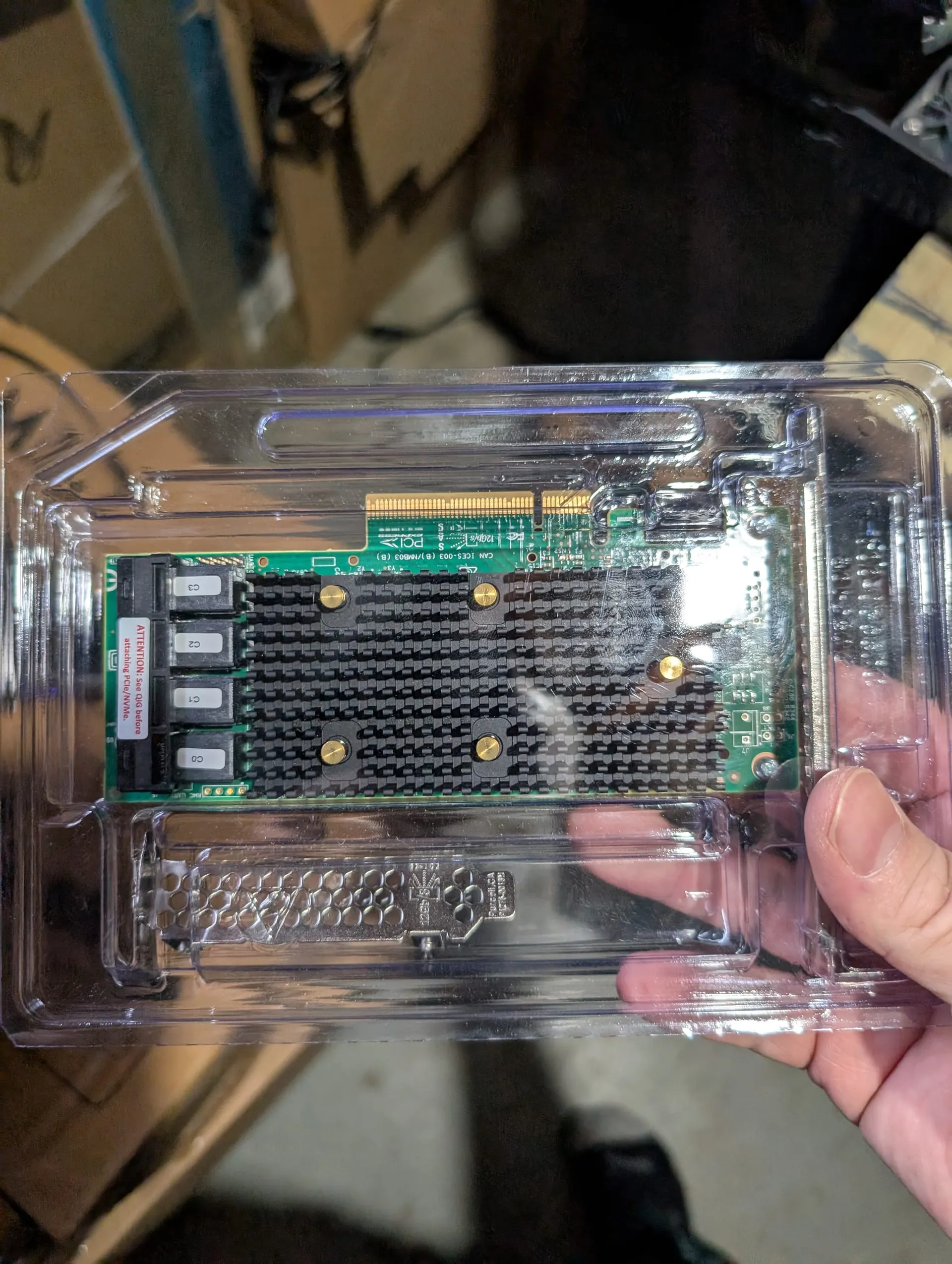 A picture of the LSI Megaraid 9400-16i brand new, in it's plastic shipping container.