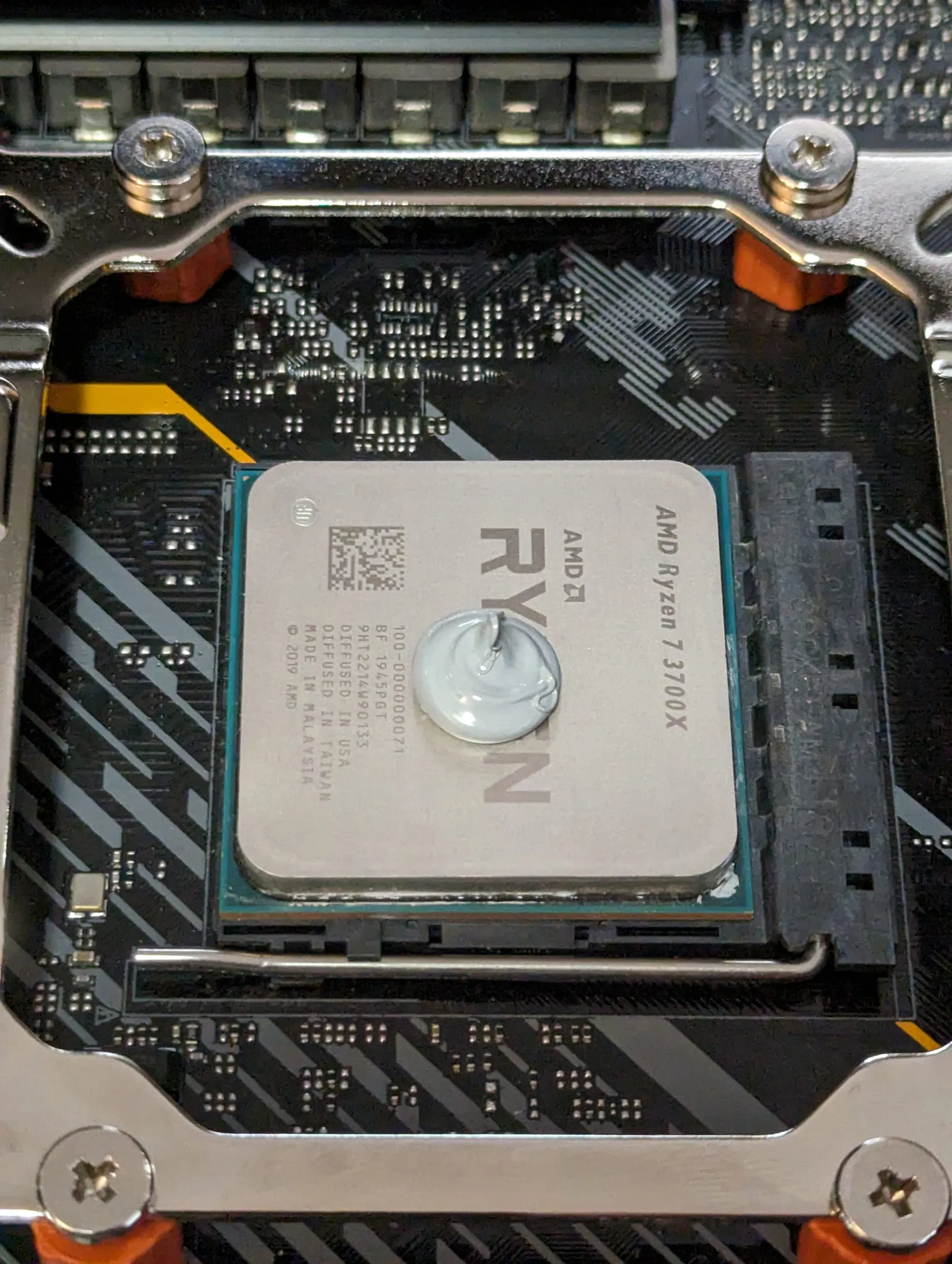 A picture of one of the installs I did with single large dot of paste, in the centre of a Ryzen 3700X.