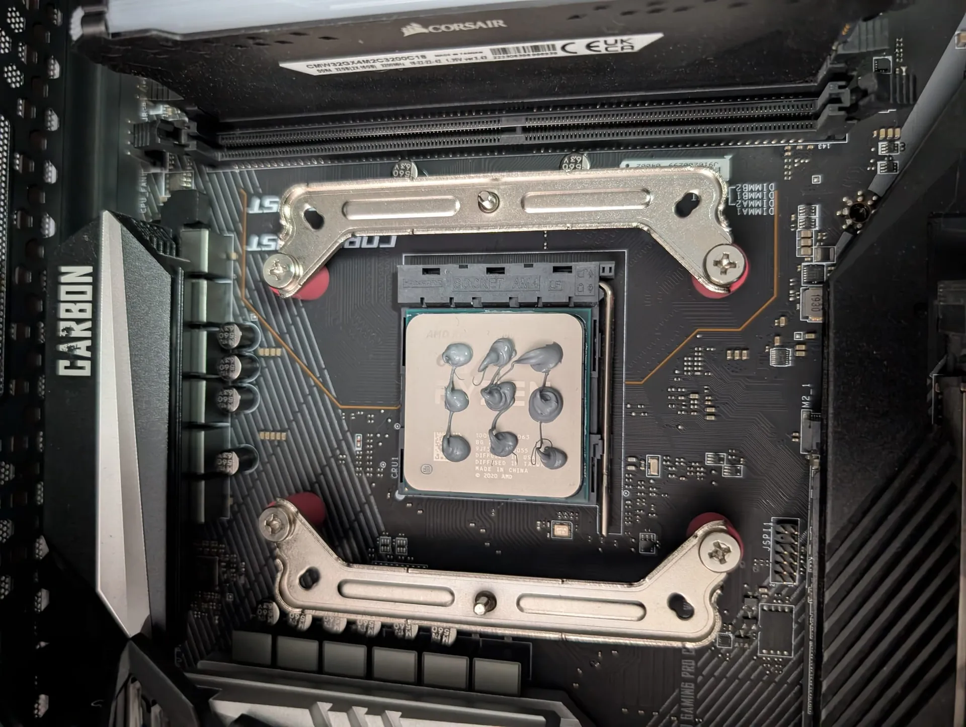 Applying thermal paste to a CPU using the multi-dot method for even coverage.