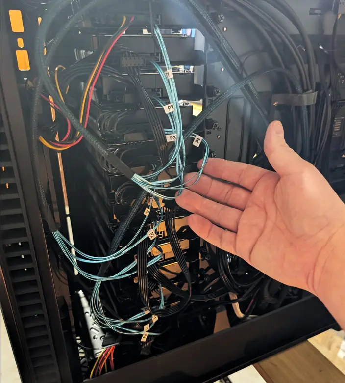 Inside view of the case with the side panel removed, showcasing a densely packed, clean layout with the 18-drive stack clearly visible.