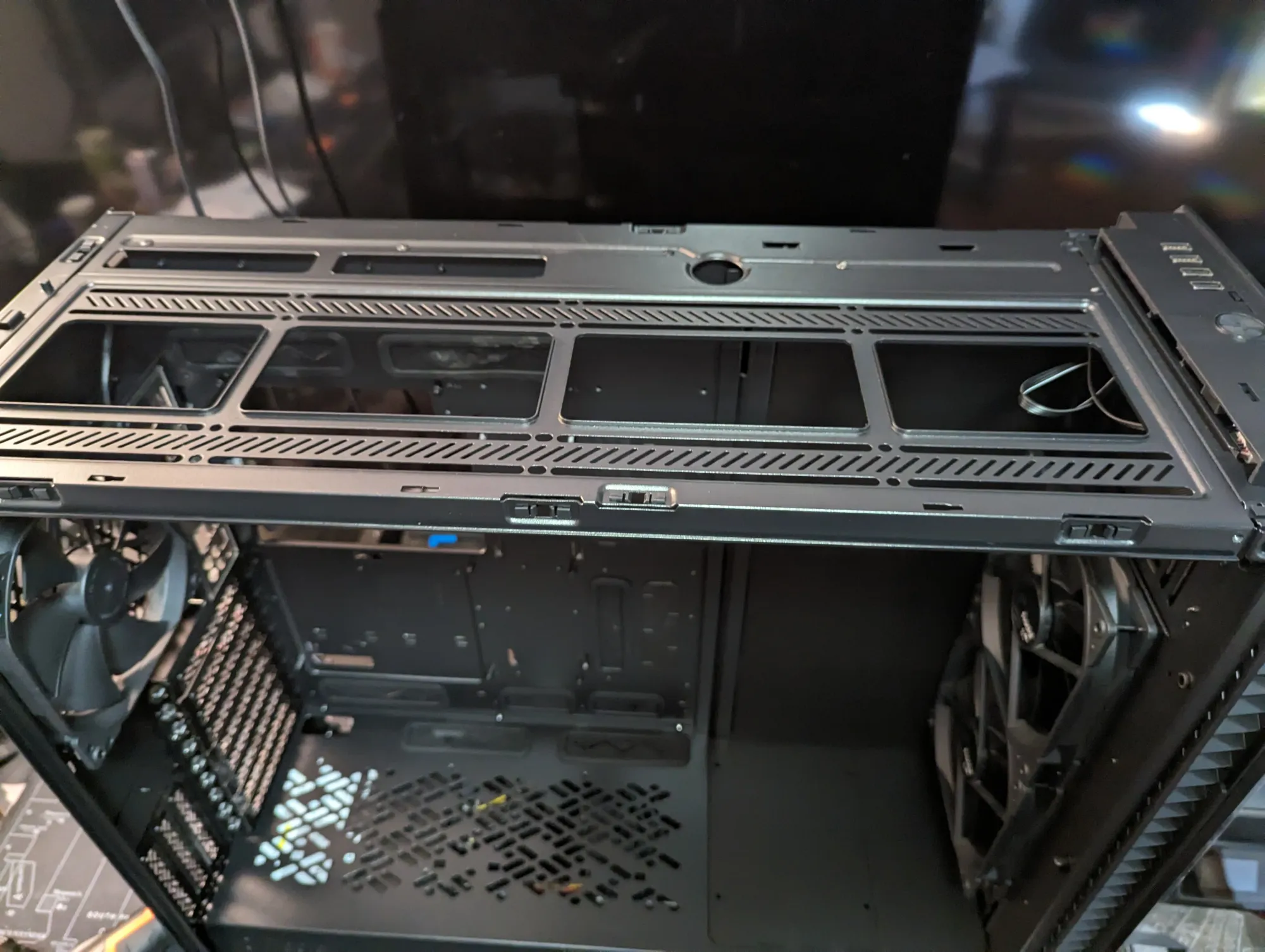 Close-up shot of the top panel of the case, showing the interchangeable ventilated top cover